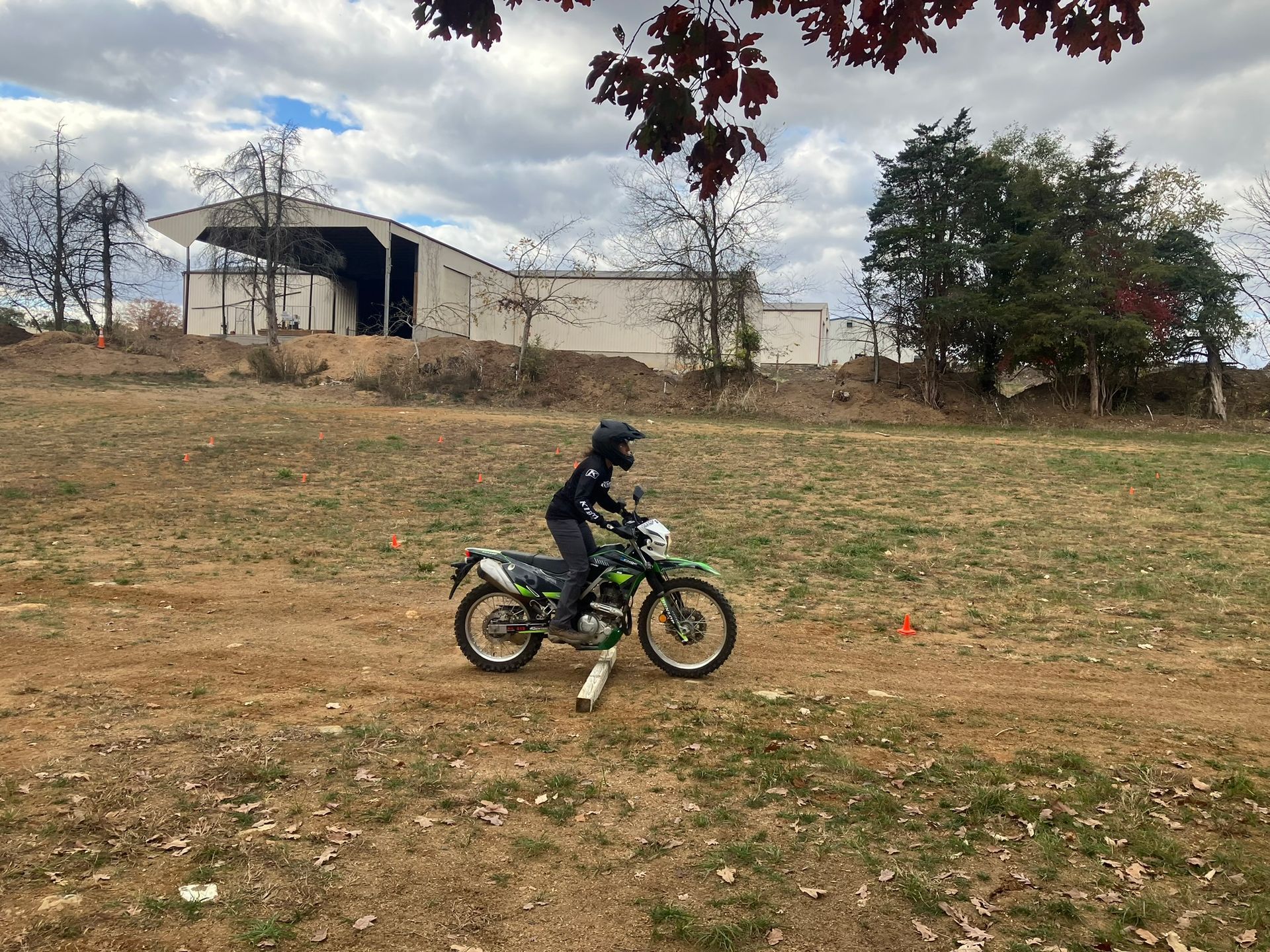 A person is riding a dirt bike on a dirt road