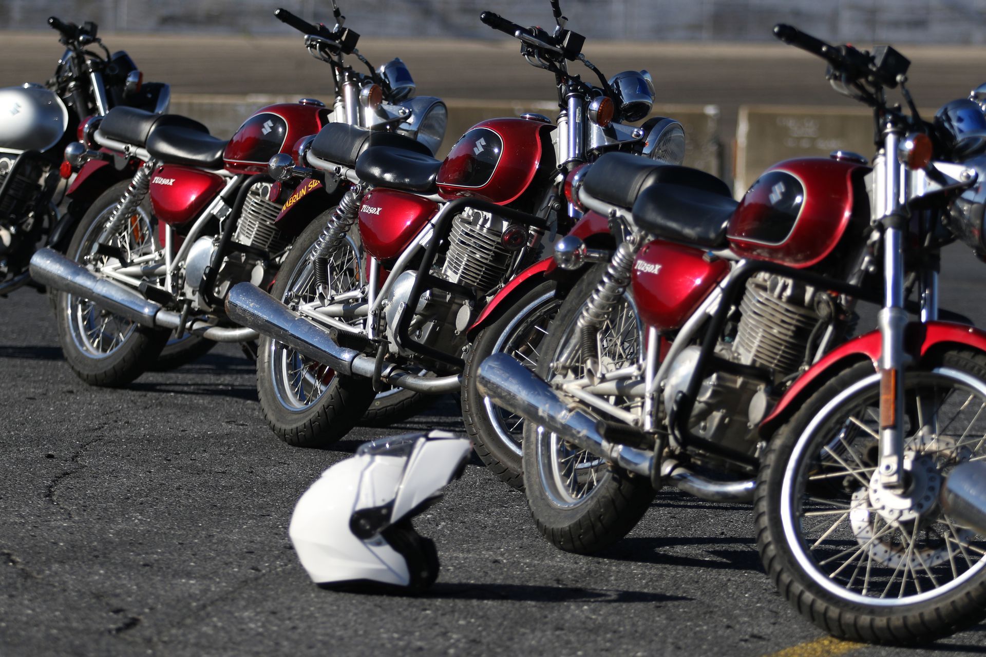 A row of red motorcycles are parked next to each other