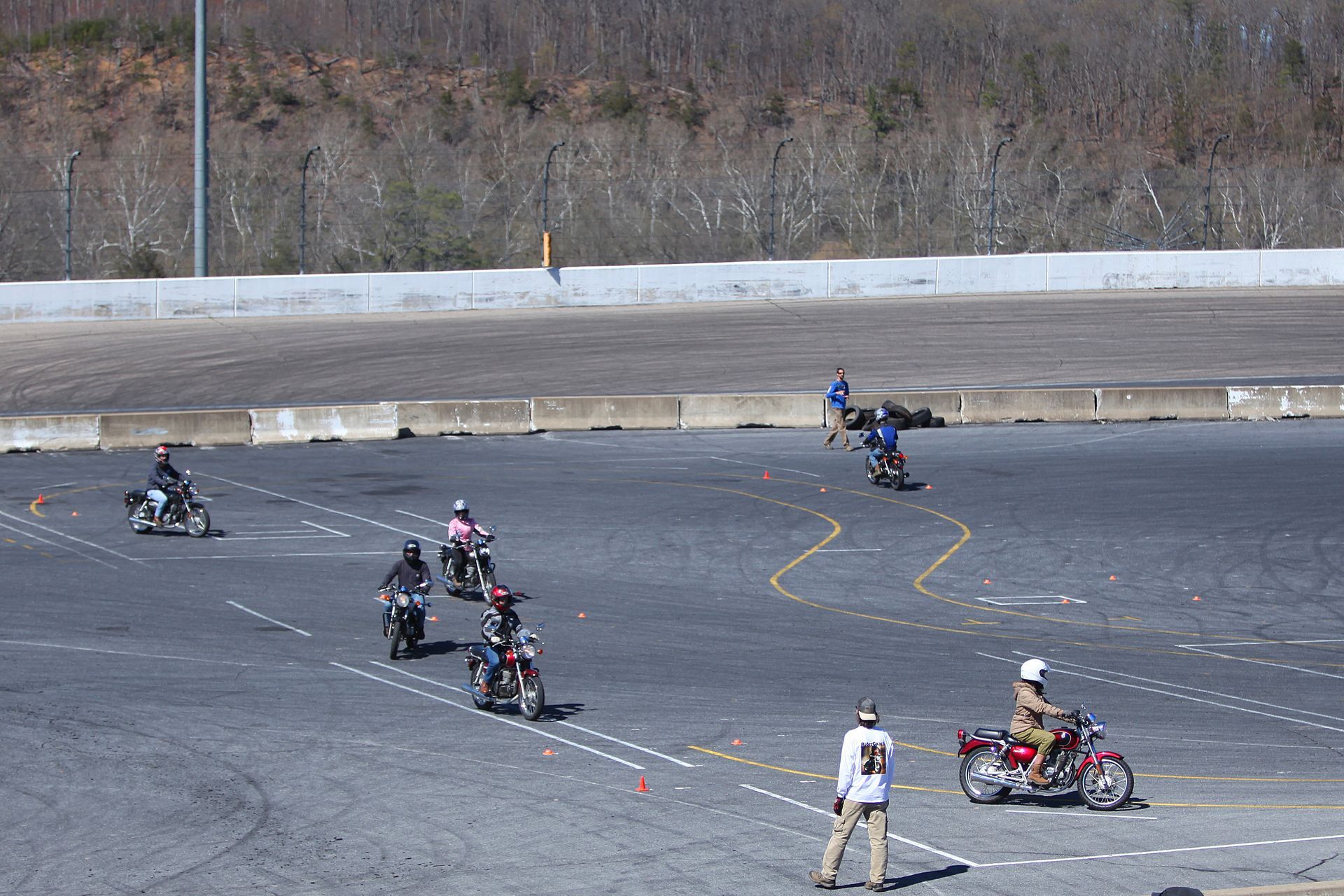 A group of people are riding motorcycles on a track