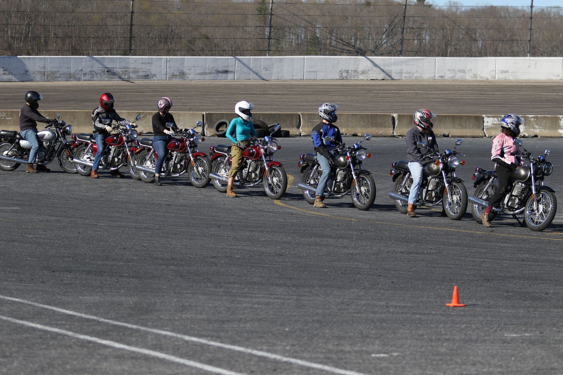 A group of people are riding motorcycles on a track