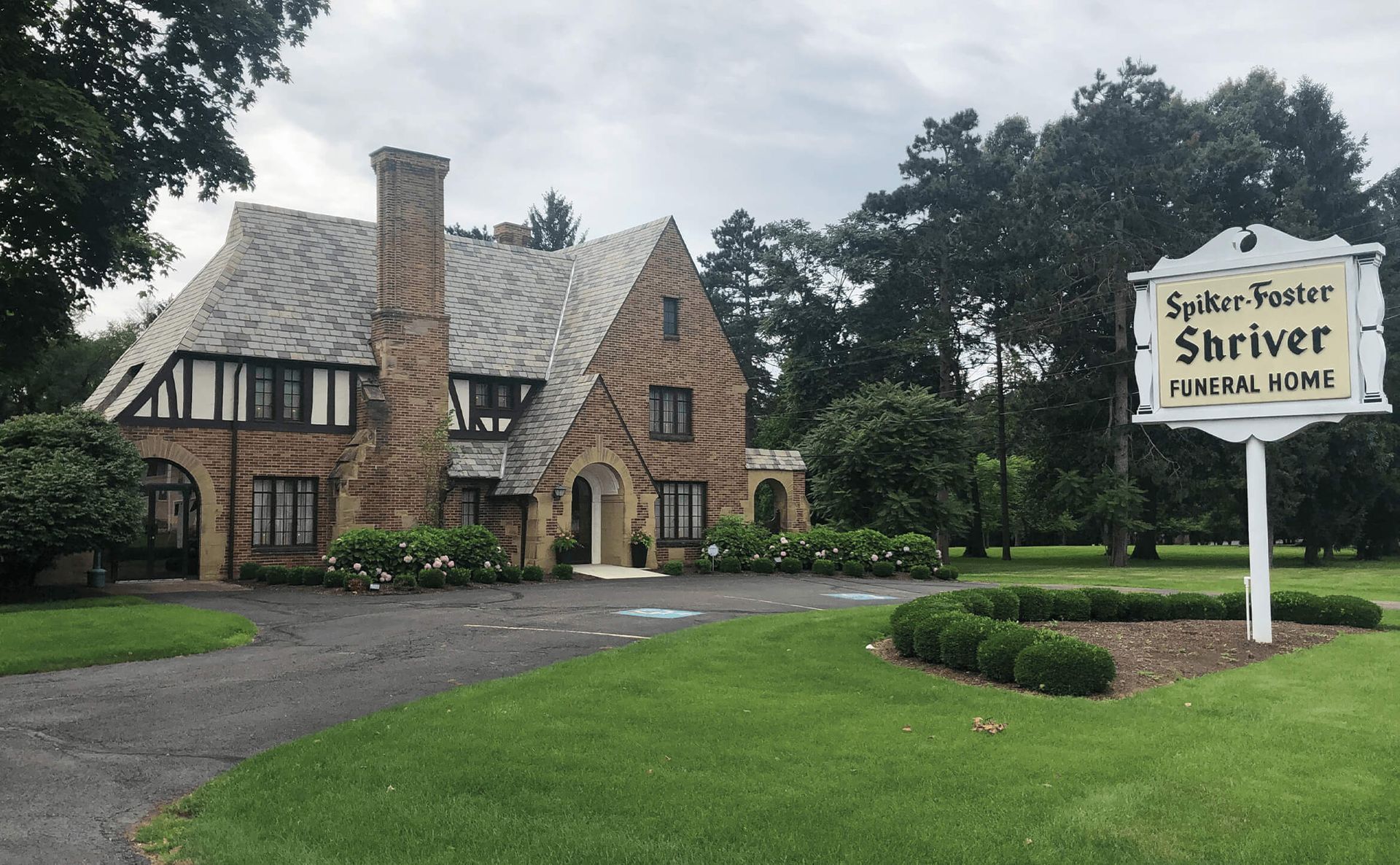 A large house with a sign in front of it that says shriver