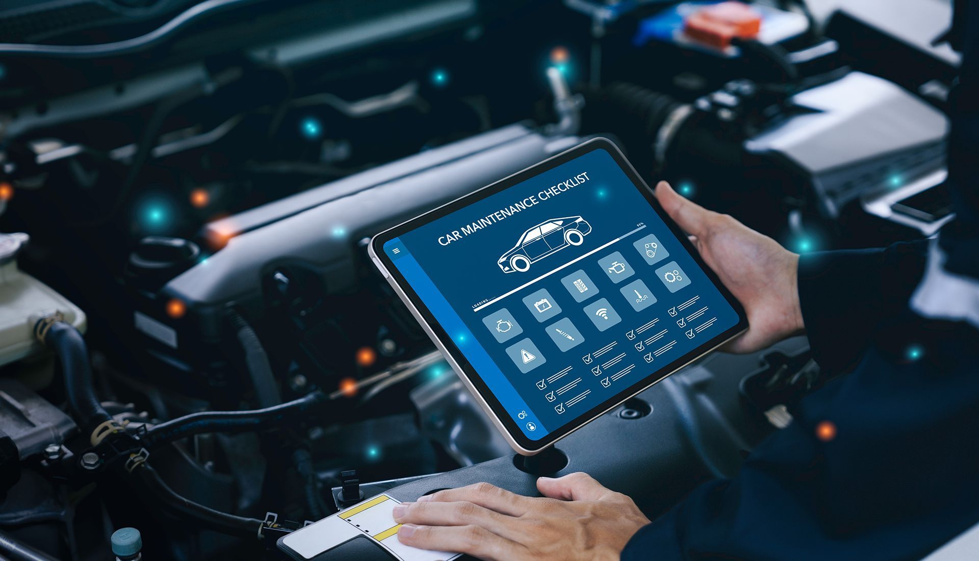 A mechanic using a tablet to diagnose a car engine. The tablet displays diagnostic information with icons.