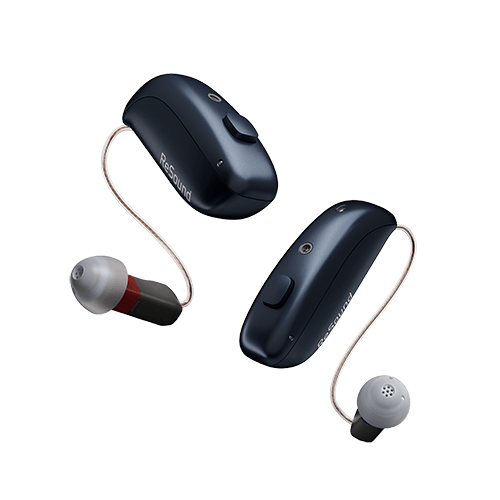 A pair of silver hearing aids made by oticon