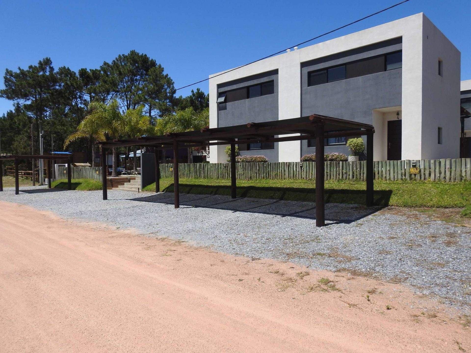 A house with a lot of parking spaces in front of it