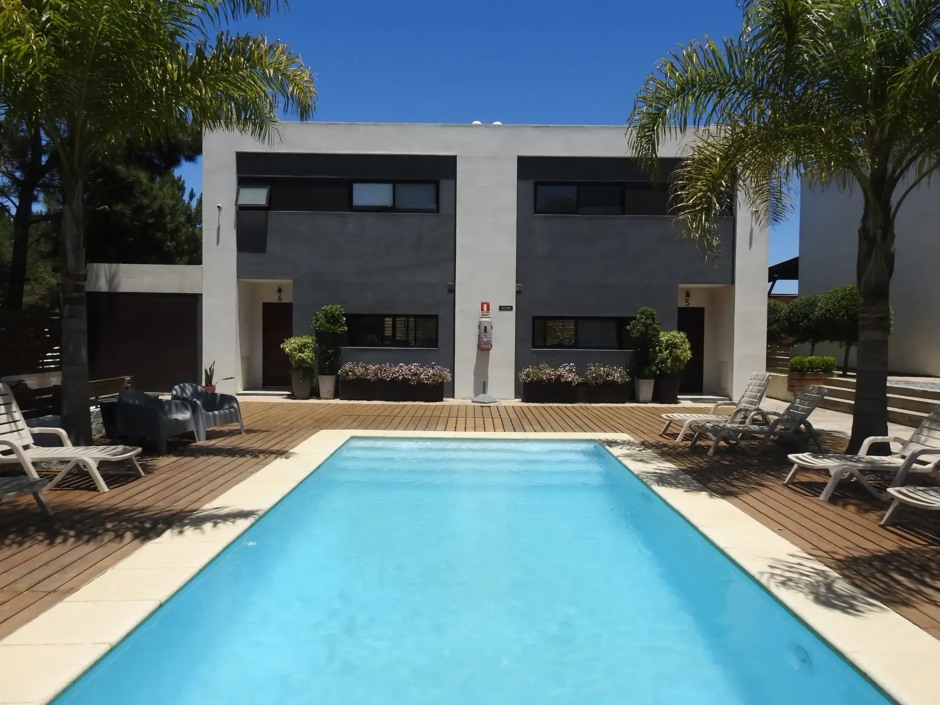A large swimming pool in front of a house