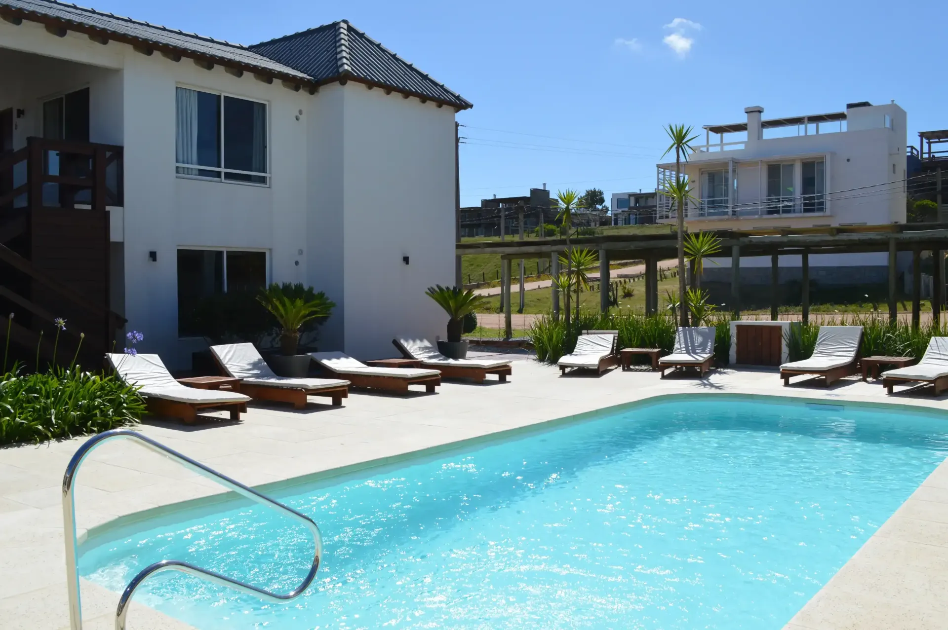 A large swimming pool in front of a white building