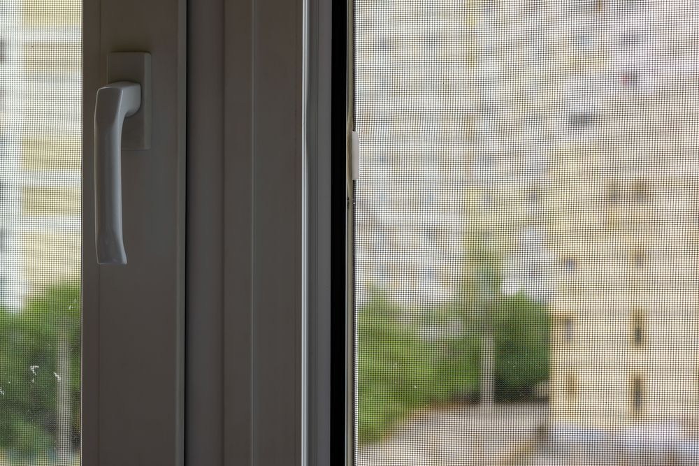 White Plastic Window Handle Attached to a Frame — Suburban Security Screens in Currumbin, QLD