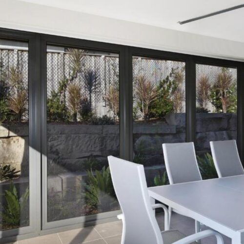 Dining Set With White Chairs is Positioned — Suburban Security Screens in Currumbin, QLD