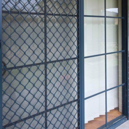 Dark Metal Security Screen Door With a Diamond Mesh Pattern — Suburban Security Screens in Currumbin, QLD