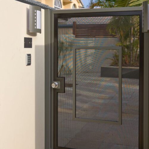 Dark Metal Gate With a Mesh Screen, a Silver Doorknob — Suburban Security Screens in Currumbin, QLD