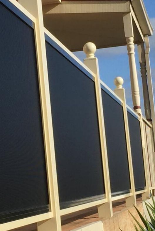 A Low-Angle View of A Porch Railing Featuring Light Cream Posts — Suburban Security Screens in Currumbin, QLD