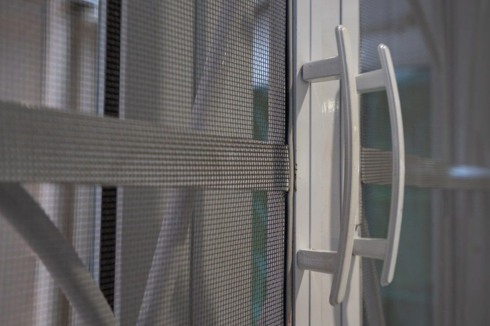 A Close-Up of A White Sliding Door — Suburban Security Screens in Currumbin, QLD