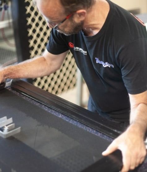 Person in a Black Shirt Working on a Black Surface — Suburban Security Screens in Currumbin, QLD