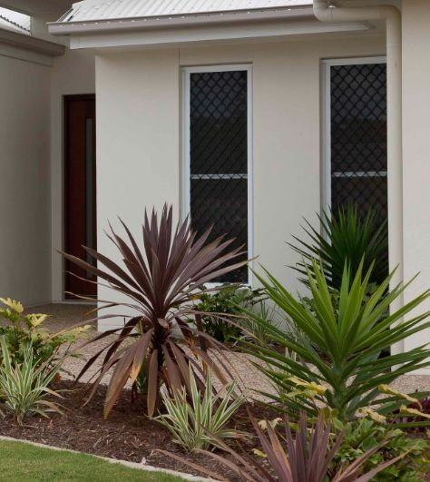 Exterior of a Modern Home With a Light-colored Wall — Suburban Security Screens in Currumbin, QLD