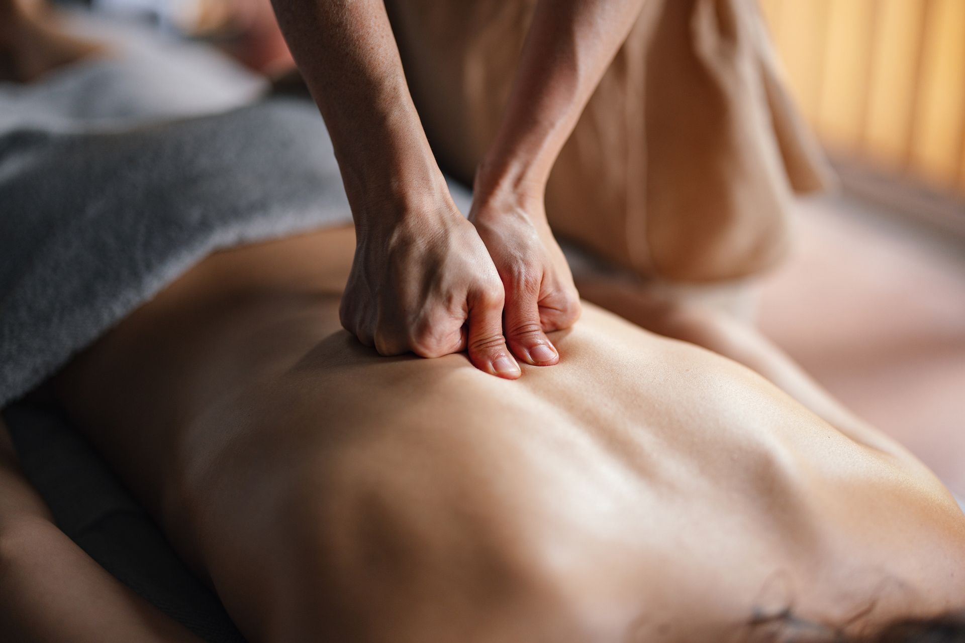 A woman is giving a man a massage in a spa.