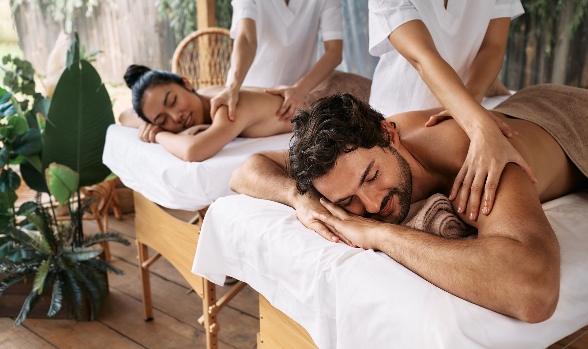 A man and a woman are getting a massage at a spa.