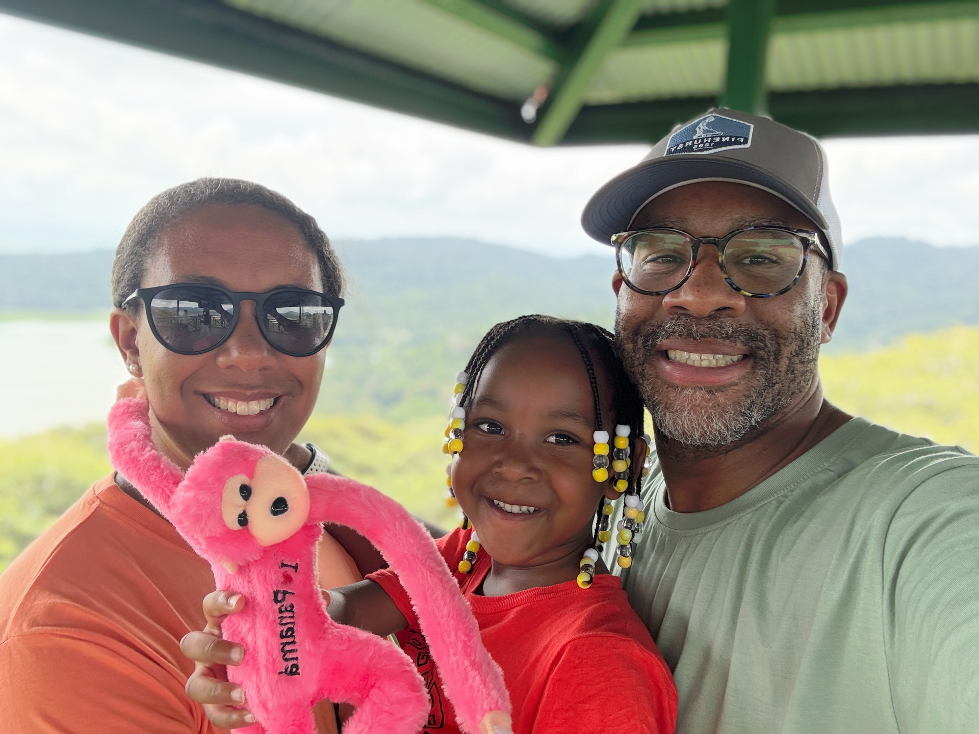 A man is taking a selfie with a stuffed animal.