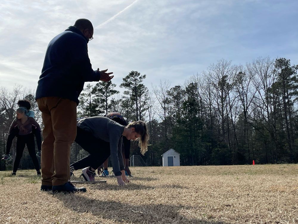 A group of people are getting ready to run on a field.