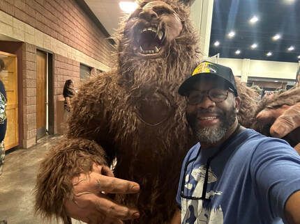 A man is taking a selfie with a stuffed animal.