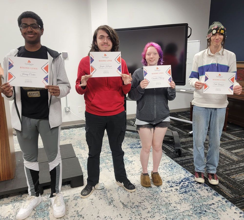 A group of people are standing next to each other holding certificates.