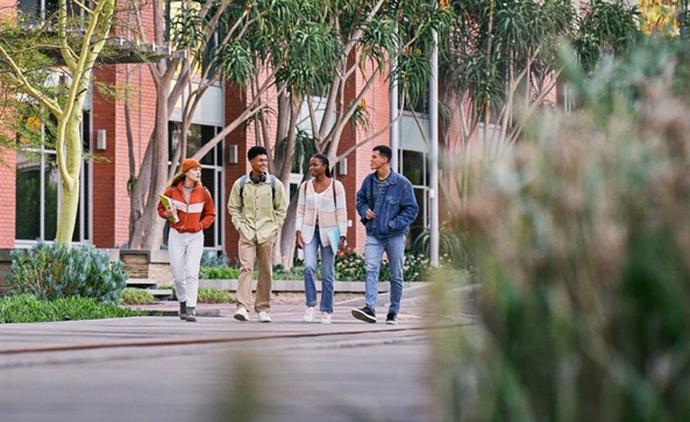 A young man in a black jacket is holding a letter