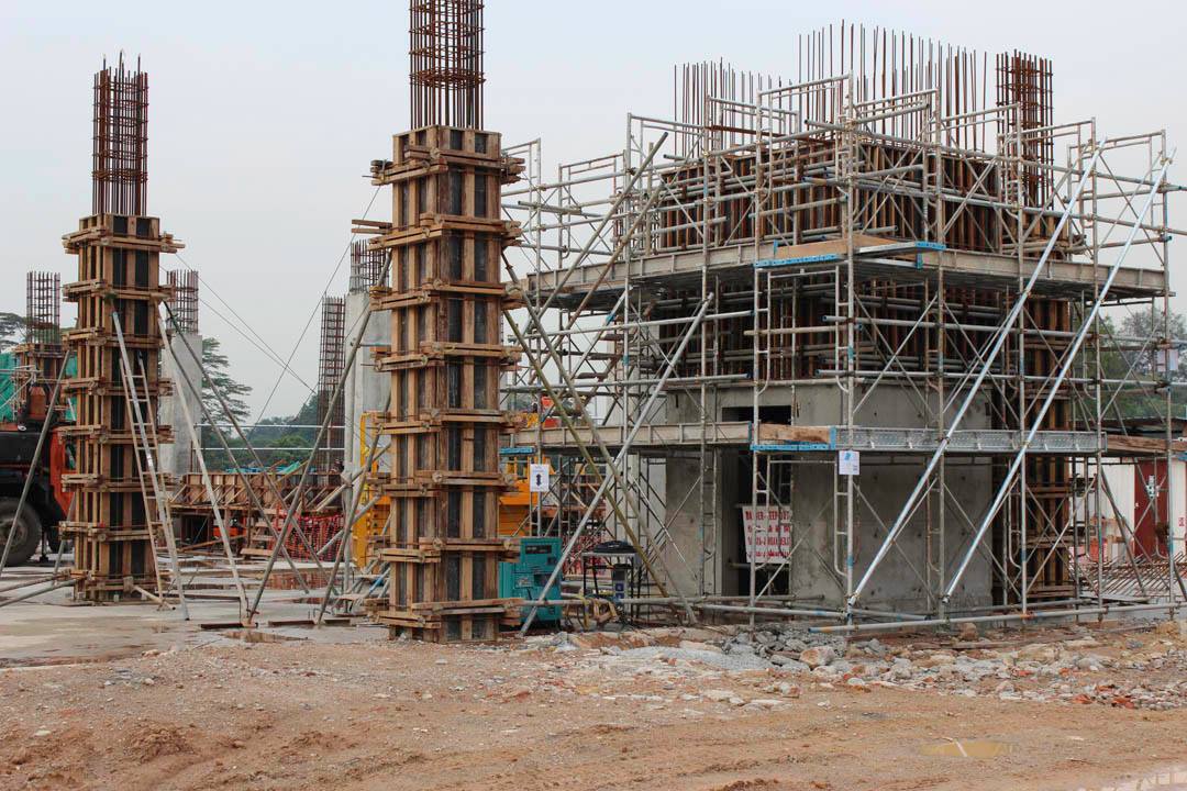 A construction site with a lot of scaffolding and pillars.