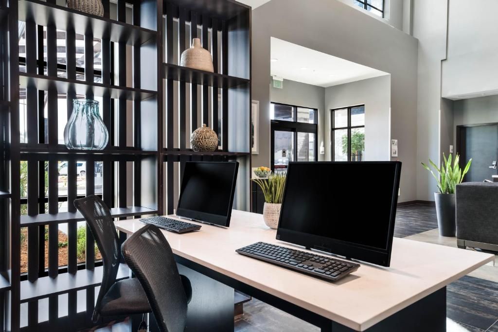 A desk with a computer and a laptop on it.