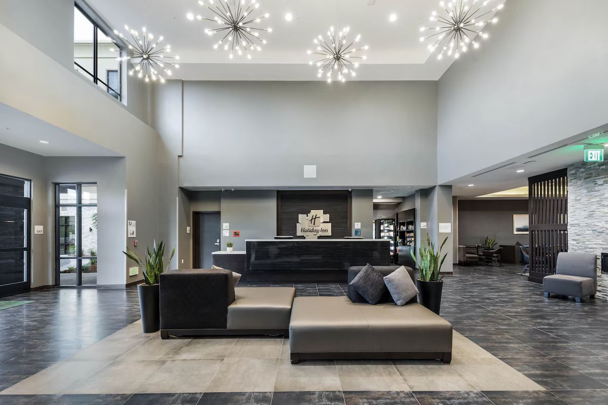 A hotel lobby with a couch and a desk