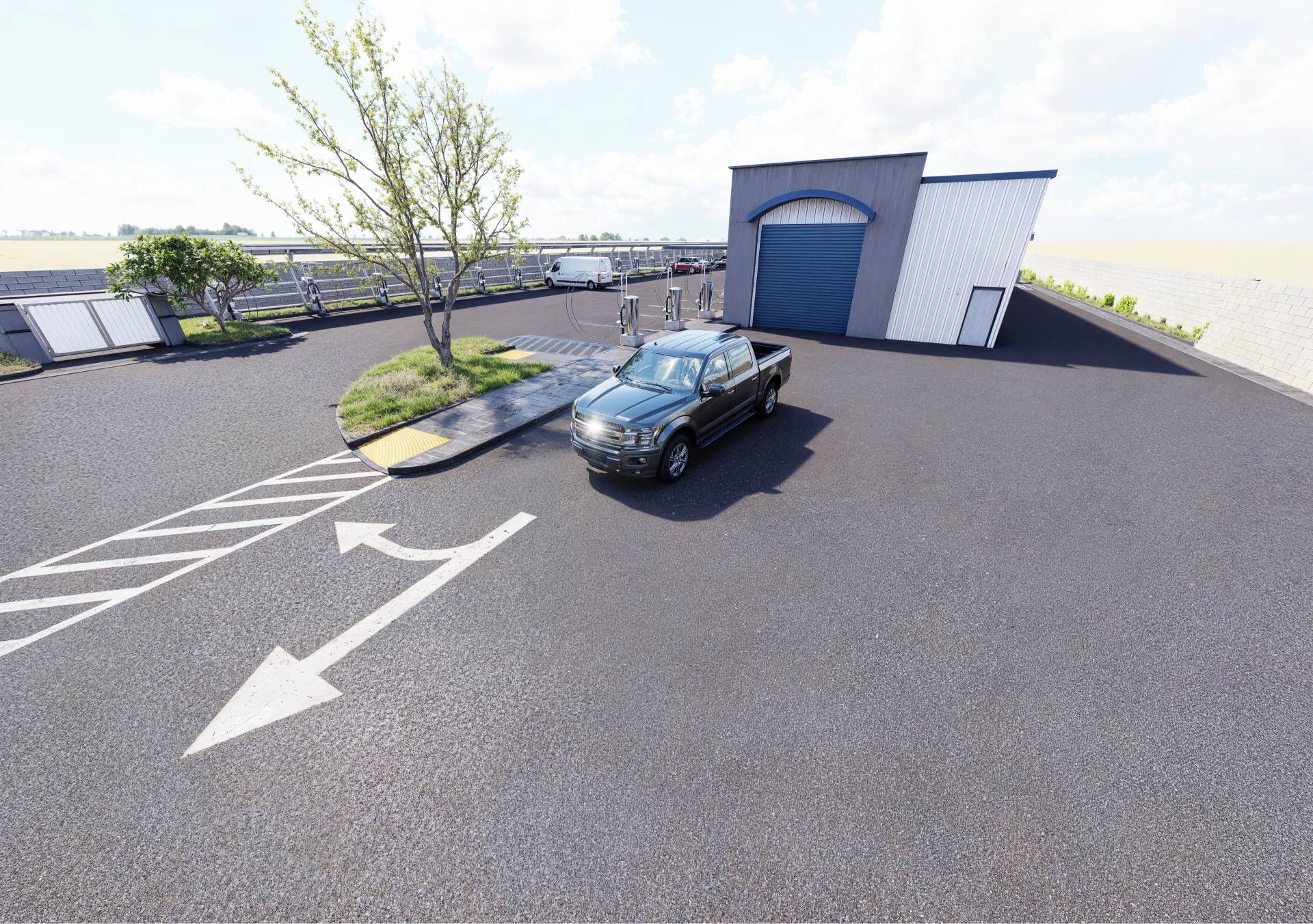 A truck is parked in a parking lot next to a building.