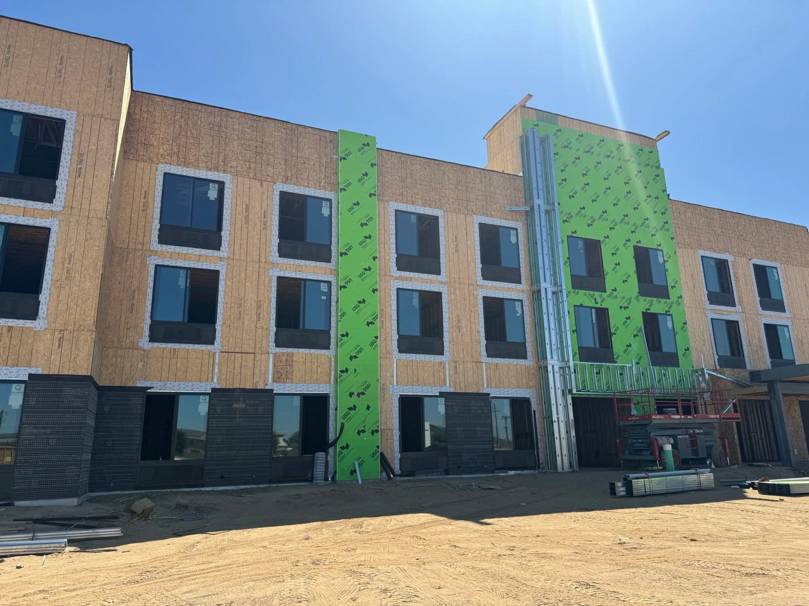 A large building with a lot of windows is being built.