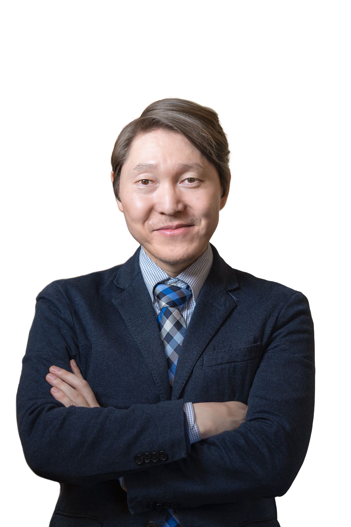 Emil Betro headshot, a man standing with his arms crossed wearing a plaid blue tie and dark blazer.