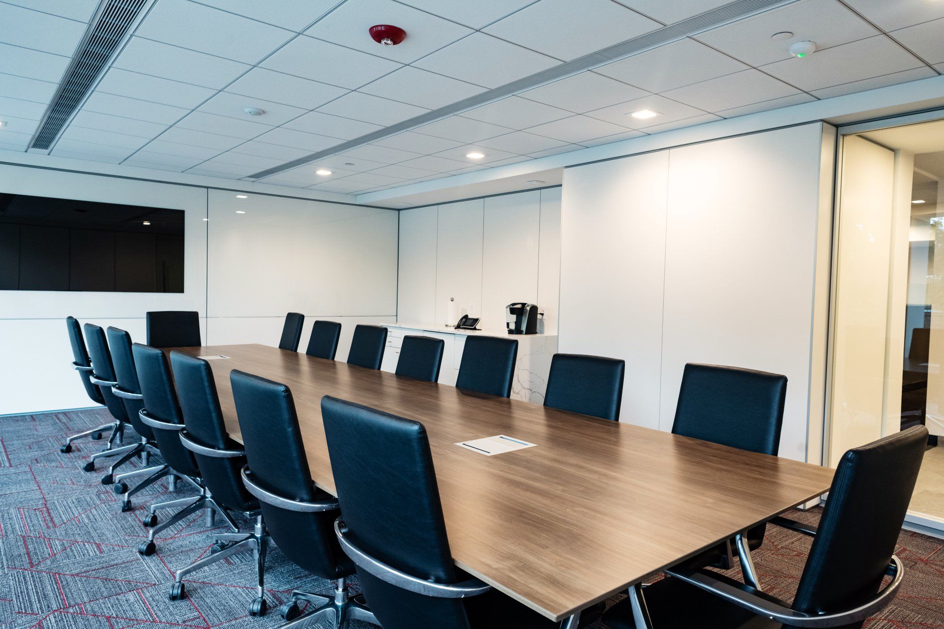 A conference room with a long table and chairs.