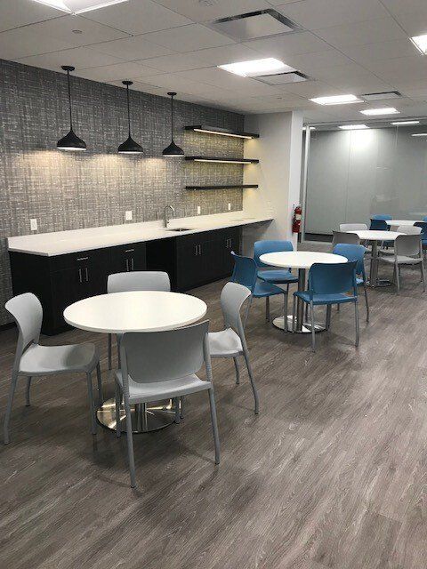 A large room with tables and chairs in it.