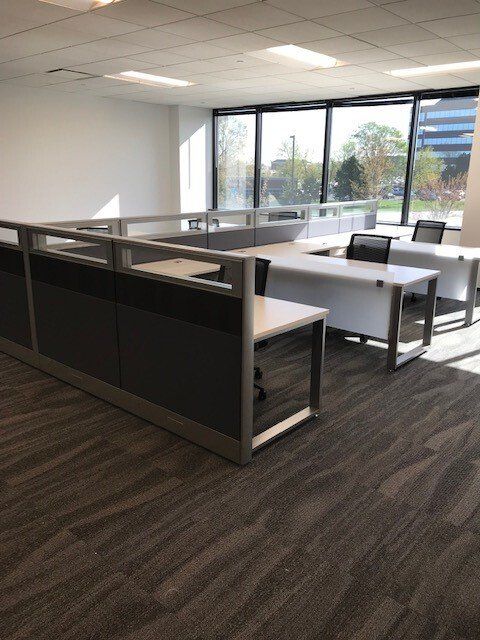 An office with cubicles and a lot of windows