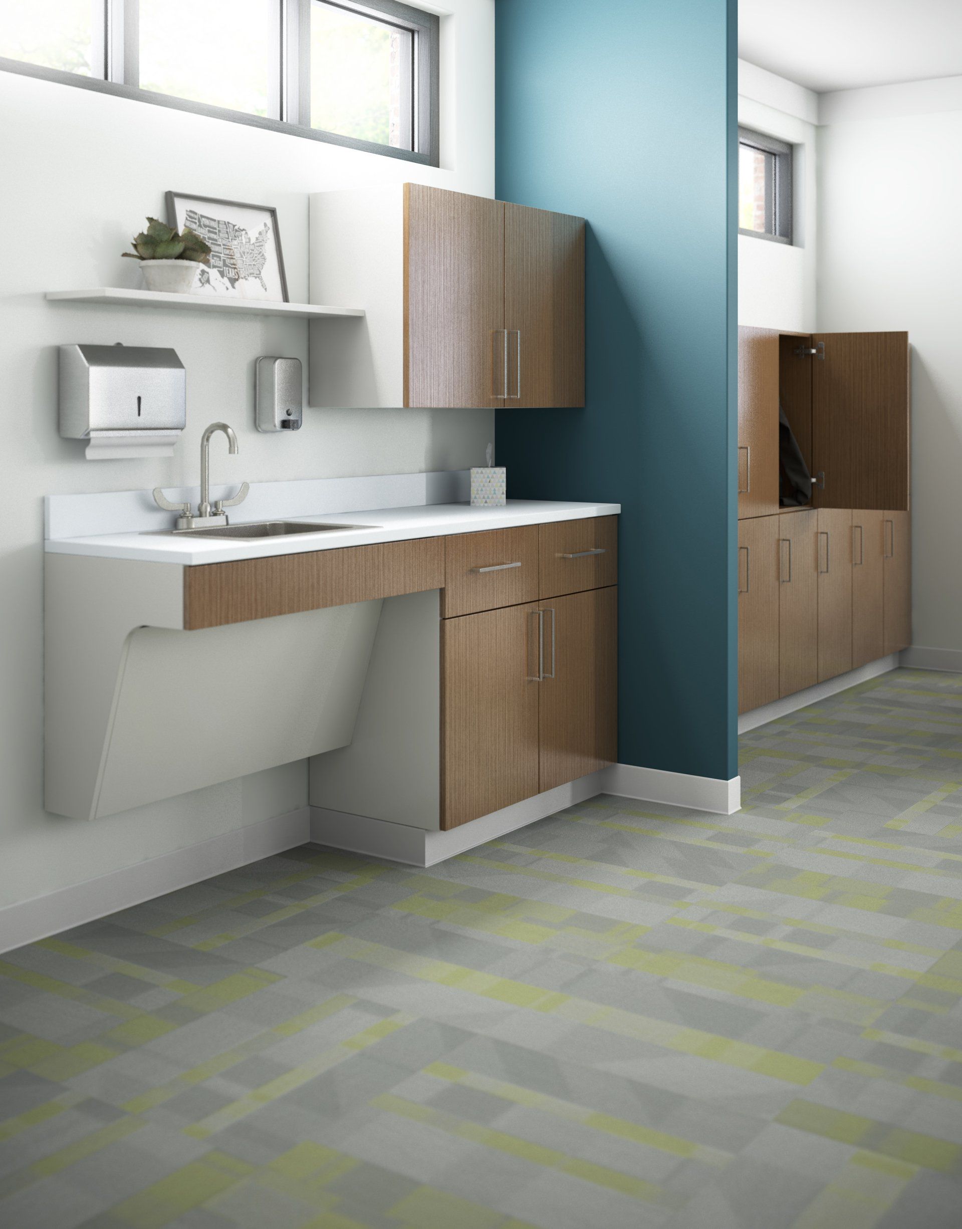 A bathroom with a sink , cabinets , and a blue wall.
