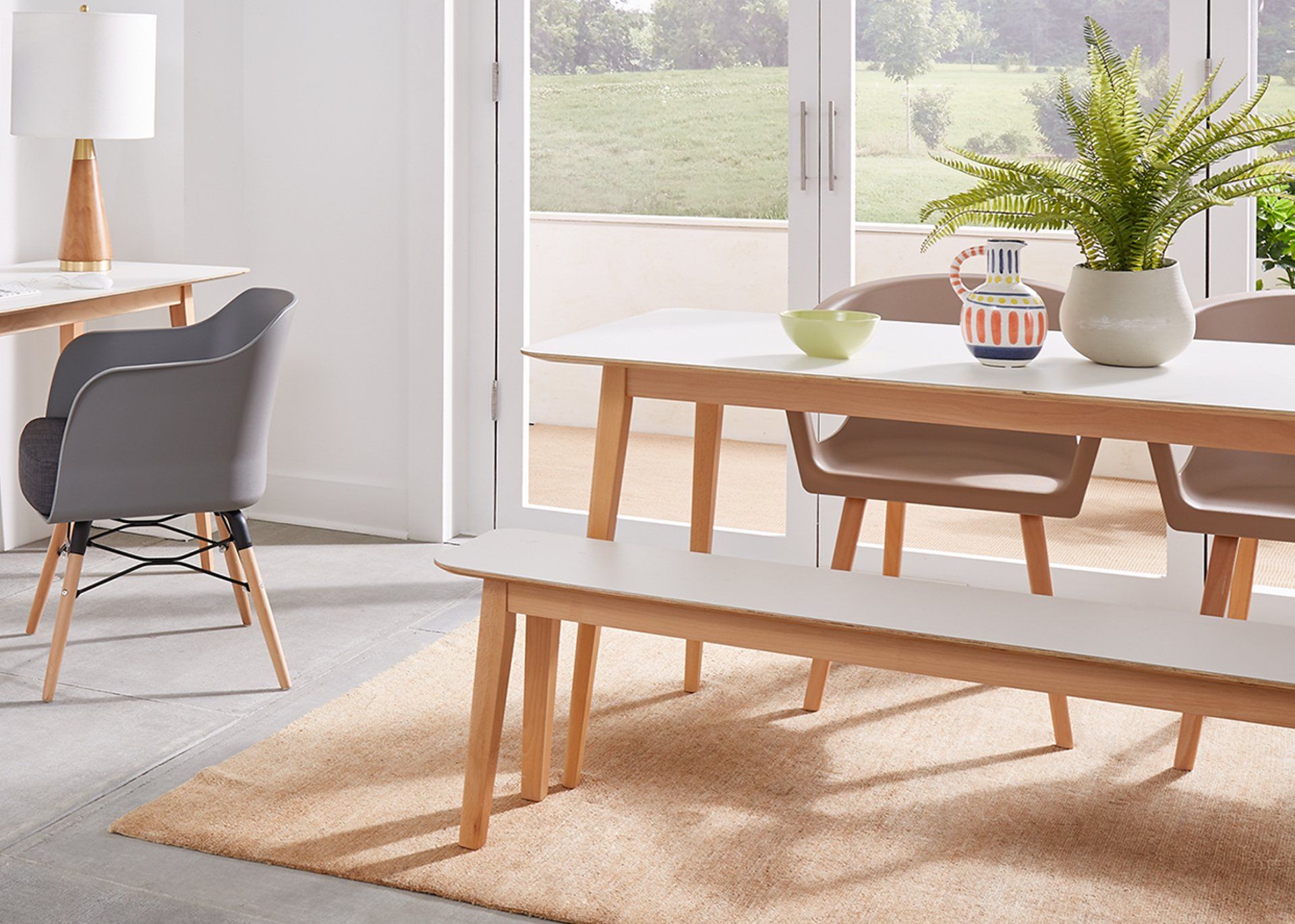 A dining room with a table and chairs and a bench