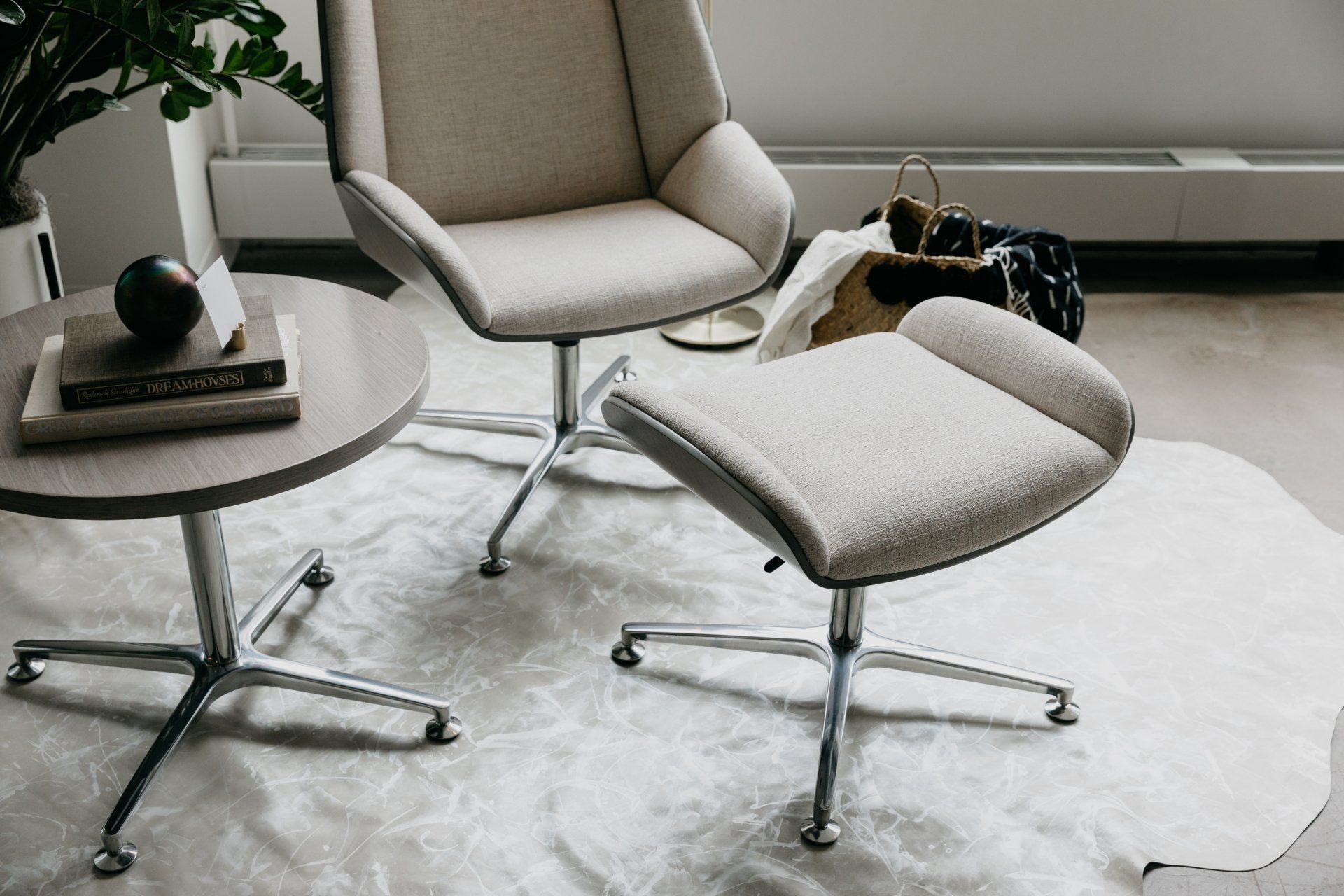 A chair and ottoman are sitting on a rug in a living room.