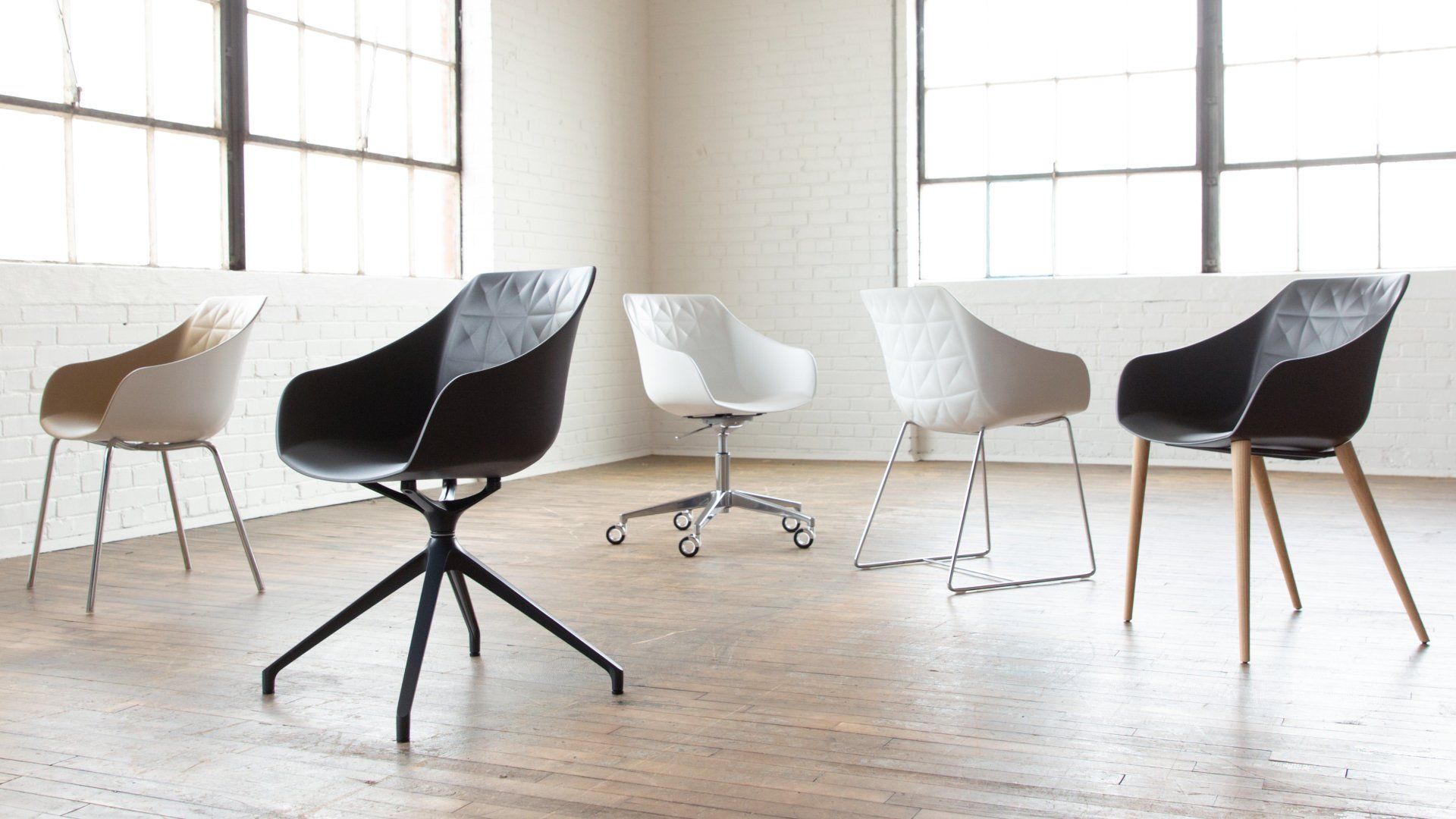 A group of chairs are sitting in a room next to each other.