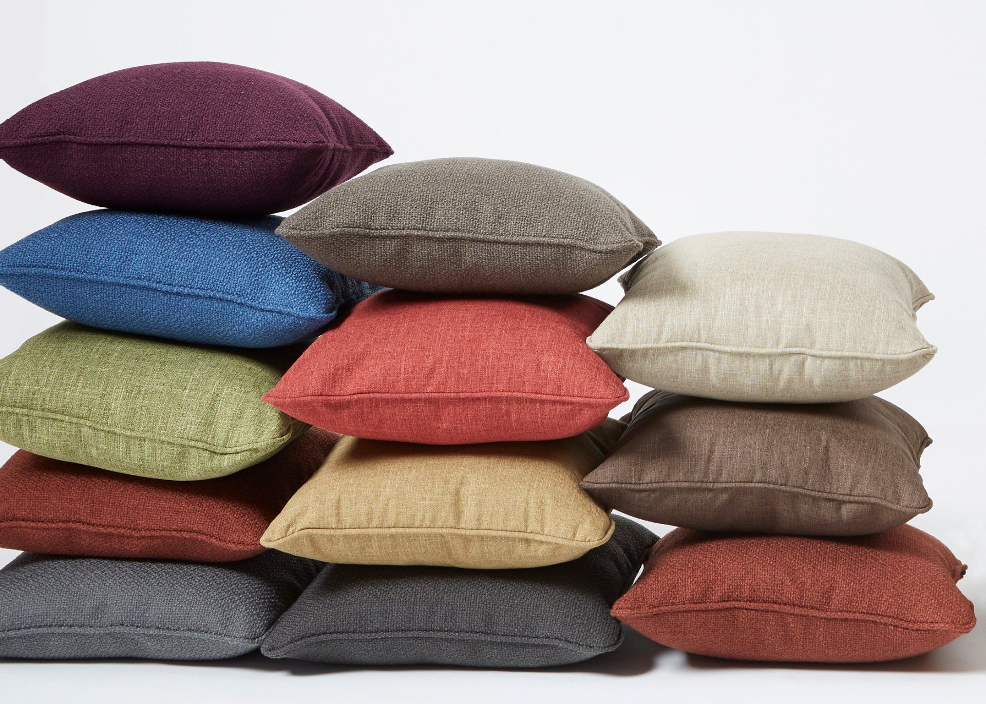 A pile of colorful pillows stacked on top of each other