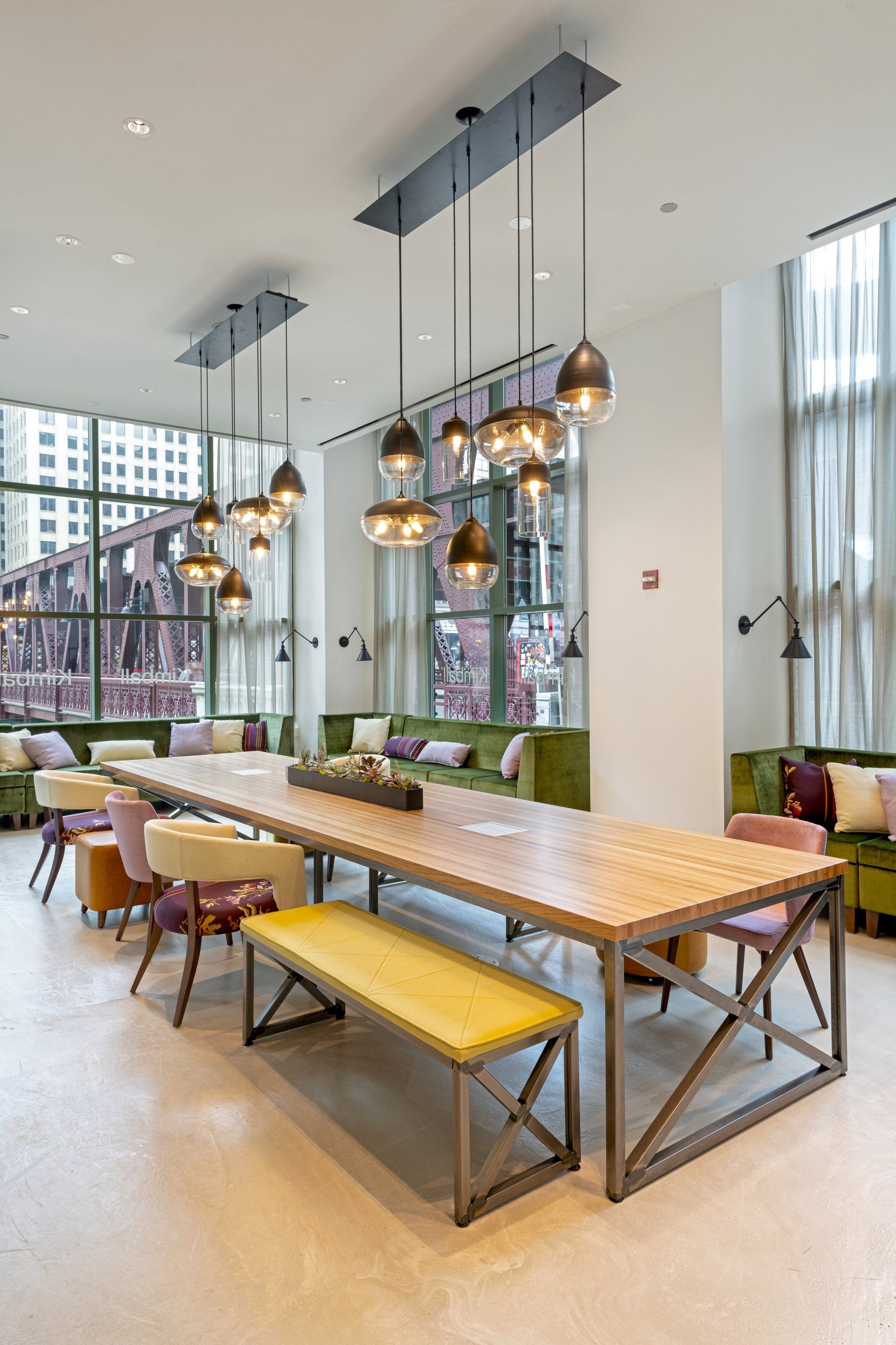 There is a long table with a bench in the middle of the room.