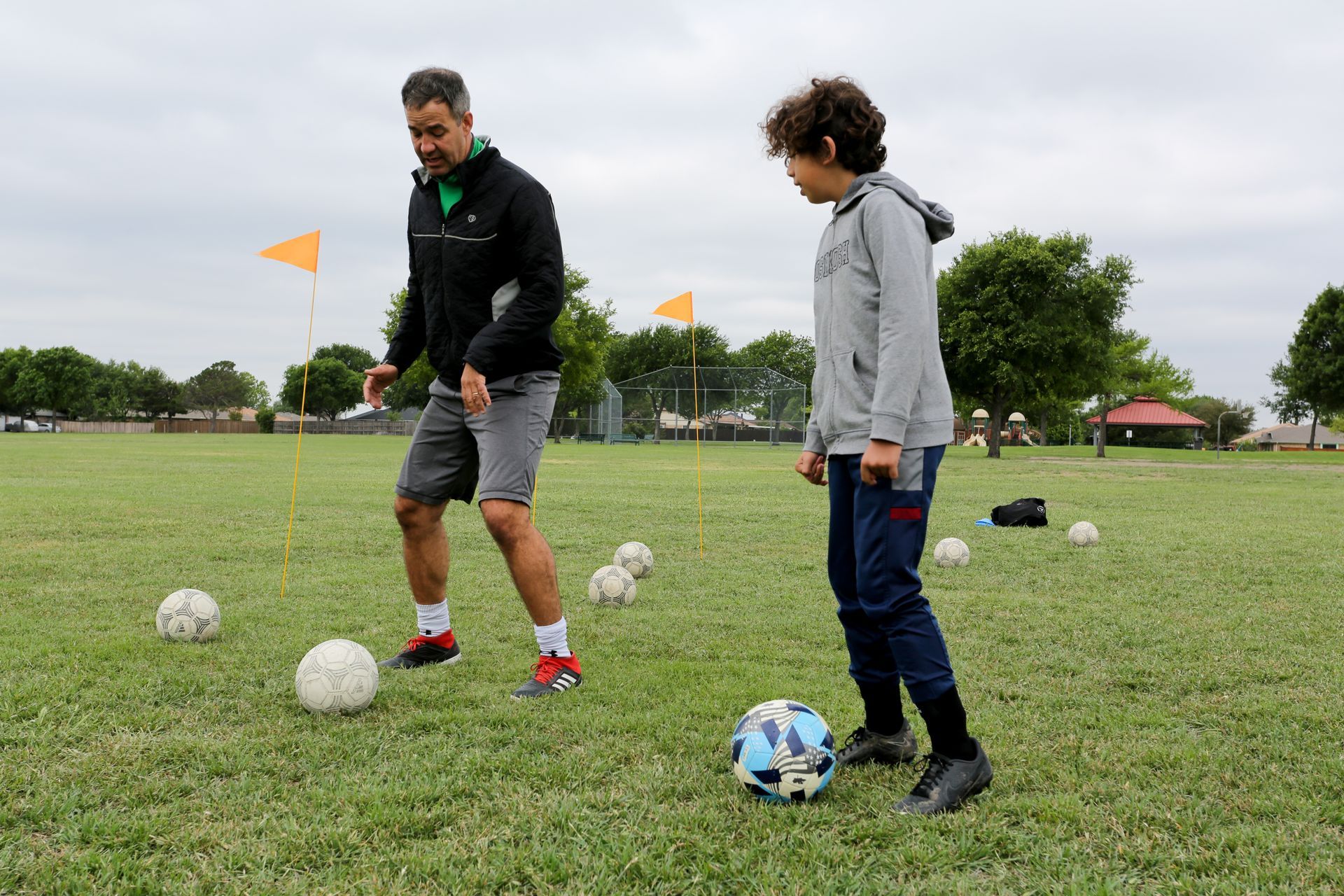 A group of young boys are playing soccer on a field.