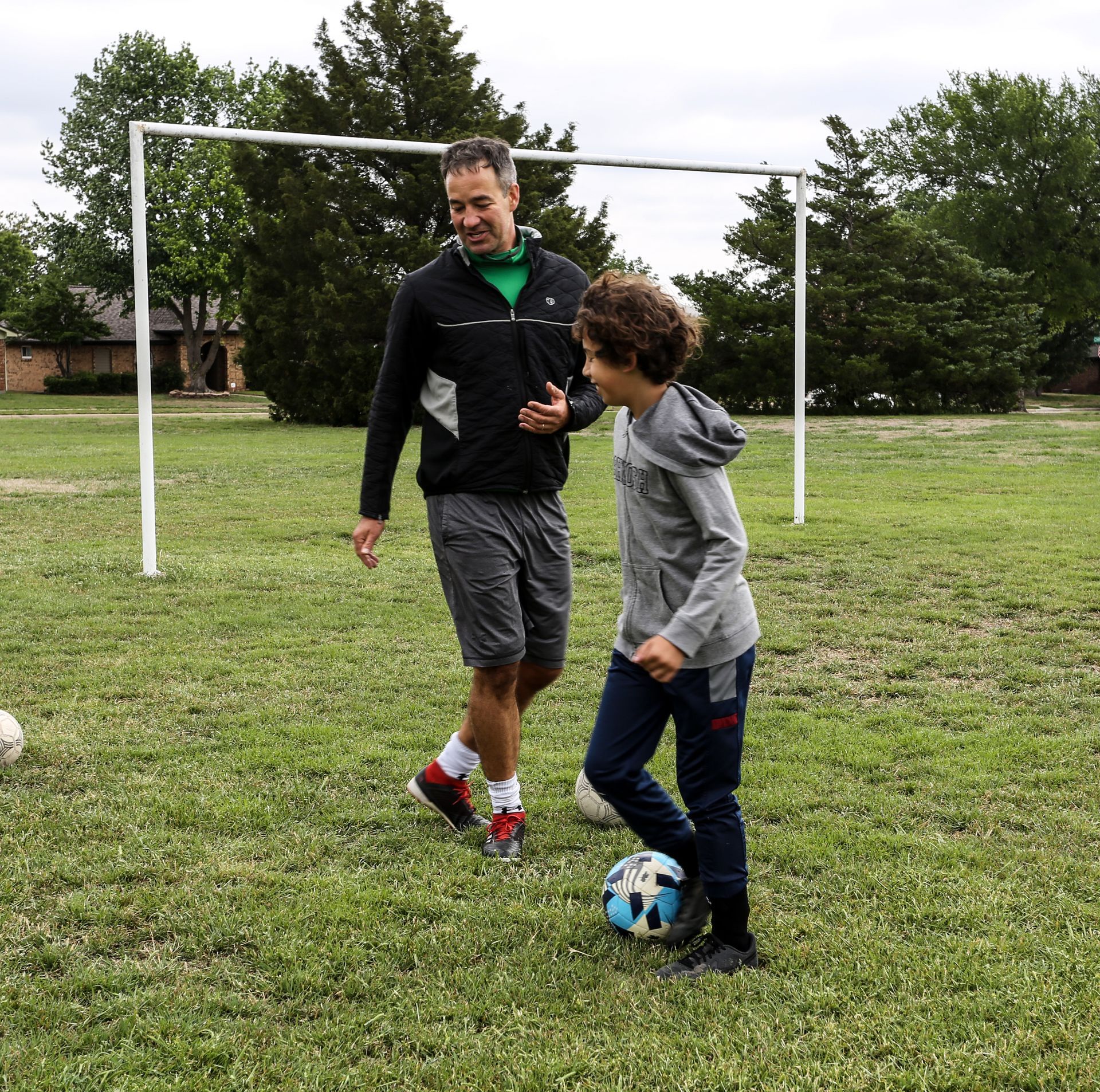 A soccer field with cones and a soccer ball on it.