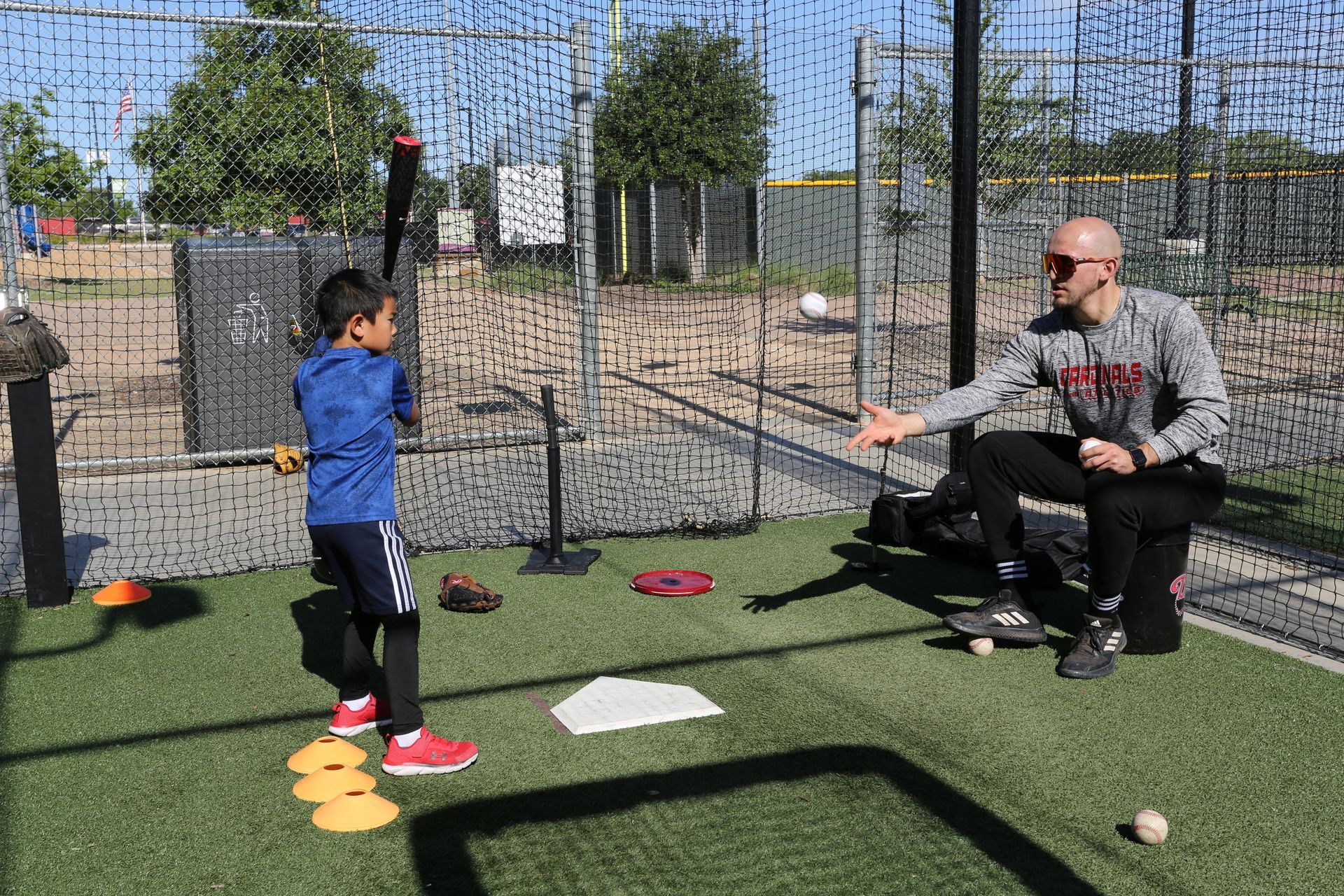A soccer field with cones and a soccer ball on it.