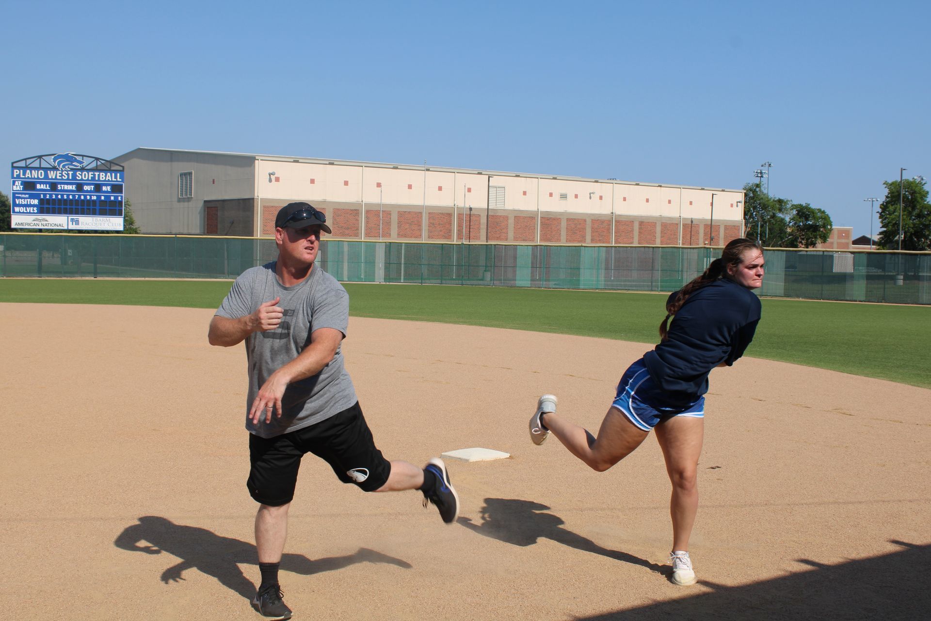A soccer player is running on a ladder on a field.