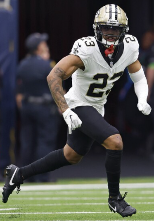 A football player is running on the field during a game.