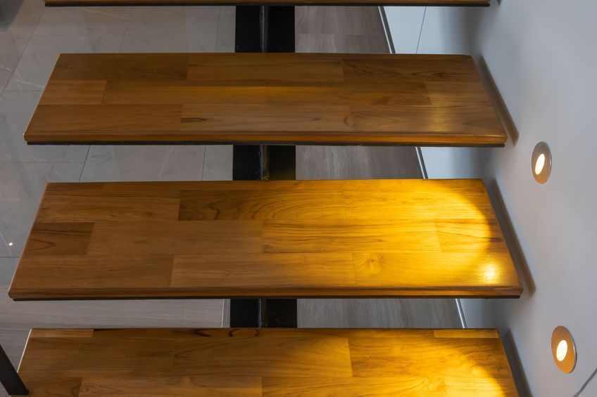 wooden treads on lighted floating stairs 