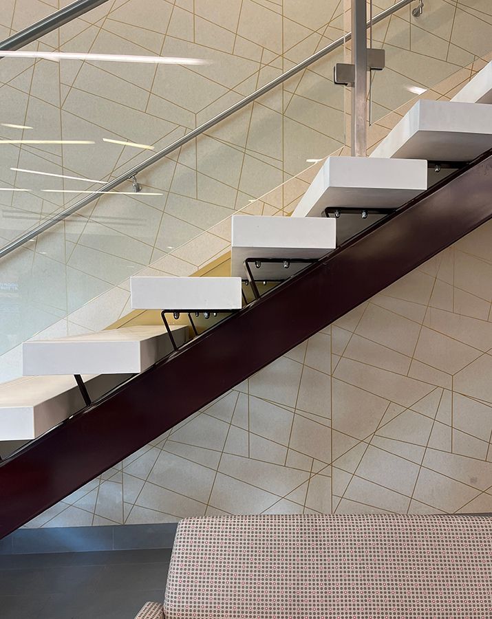 heavy white treads bolted to stringer in lobby of commercial building