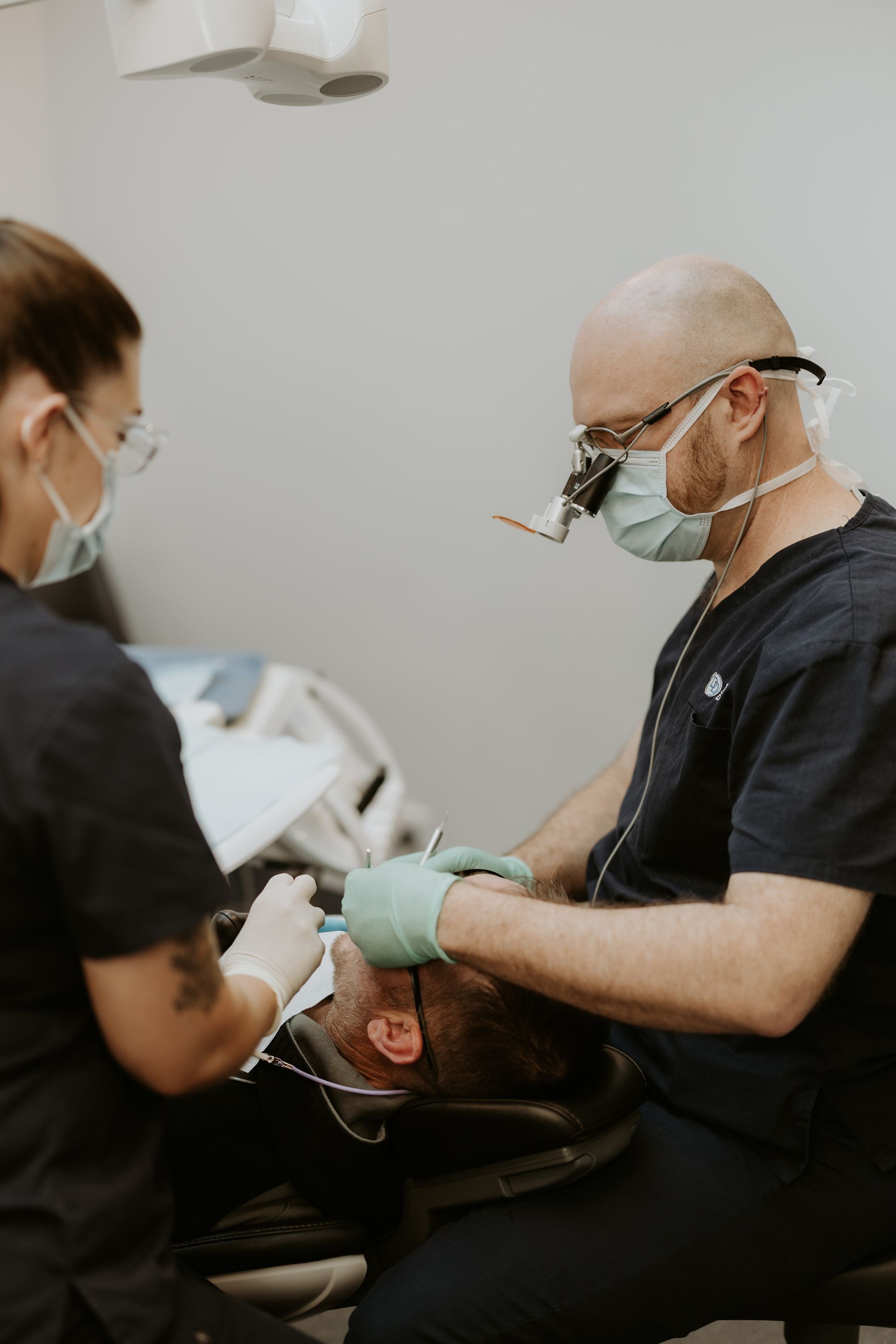 Dentist and Assistant Working on a Patient's Teeth in a Dental Office — Dubbo Dental in Dubbo, NSW