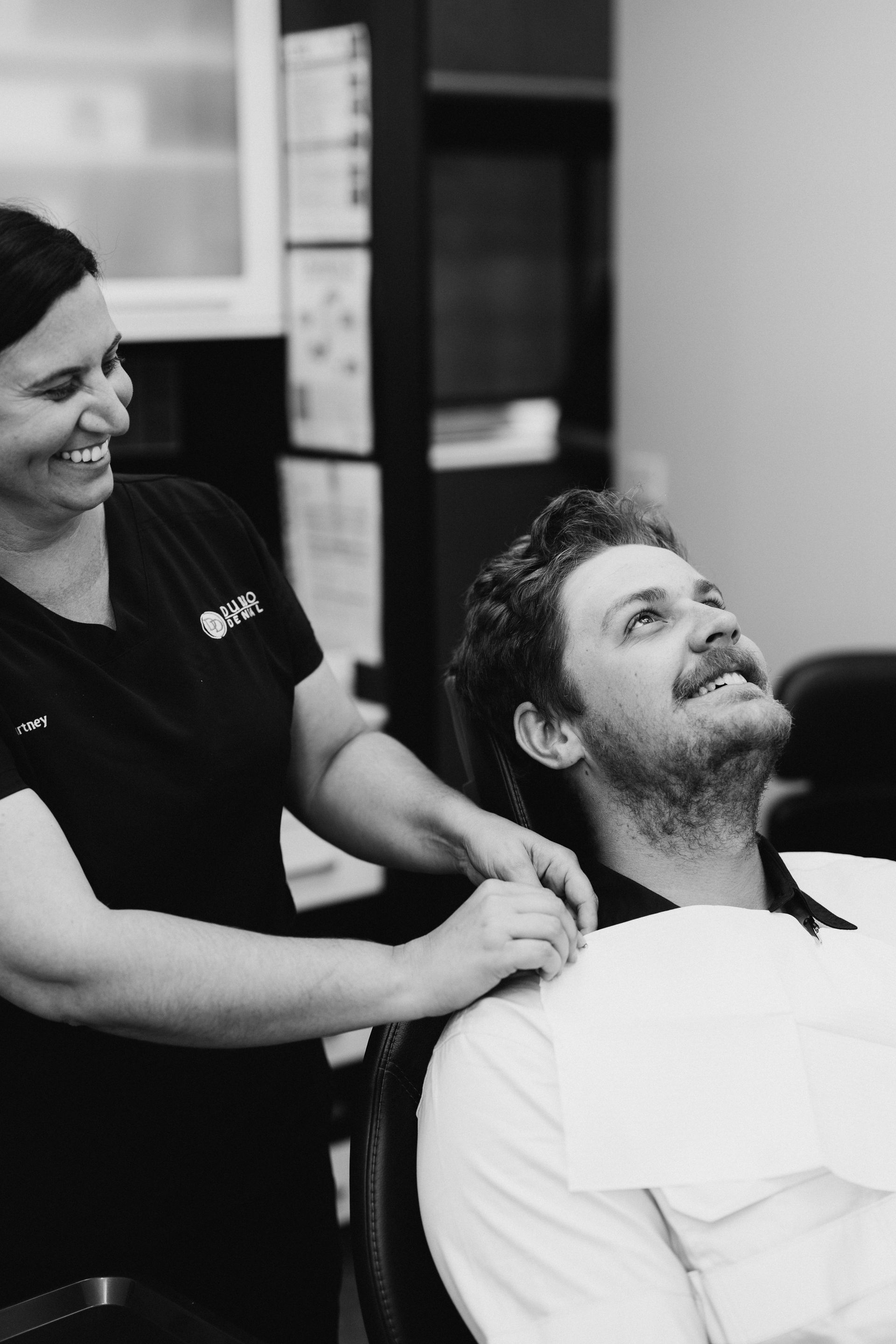 Dentist Smiles at a Patient in a Dental Chair — Dubbo Dental in Dubbo, NSW