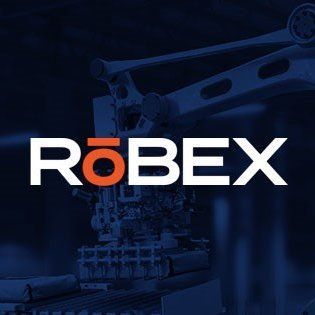 A crane is lifting a large object in front of a building.